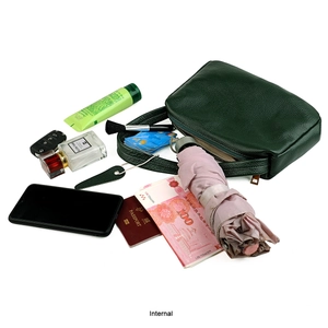 Internal storage capacity of green pebbled leather shoulder bag with gold zipper