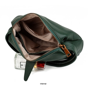 Detailed view of the dark green leather bag interior with multiple compartments