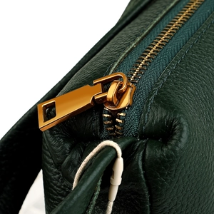 Deep green pebble grain leather underarm bag with premium gold zipper and hardware