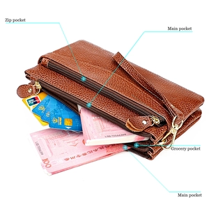 Detail view of leather bag interior showing zip pocket, main pockets and card slots