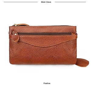 Detailed view of brown lychee grain leather crossbody bag with dual zipper and gold hardware