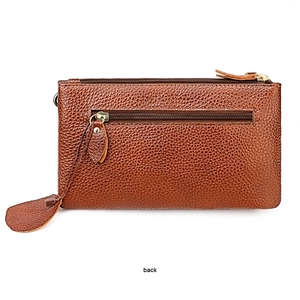 Detail view of the back of a brown pebble leather crossbody bag with a gold zipper pocket