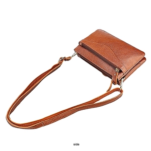 Detailed side view of brown lychee grain leather crossbody bag with triple zippers