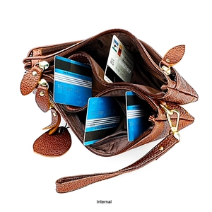 Internal view of brown leather bag showing multiple zipper compartments and card slots