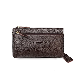 Detail of dark brown lychee grain leather crossbody bag with golden metal zipper