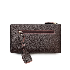 Macro detail of dark brown pebble grain genuine leather shoulder bag with zipper pocket