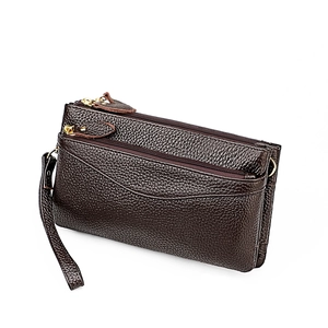 Close-up of dark brown lychee grain leather handbag with triple zipper and gold hardware