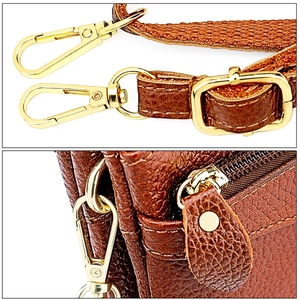 Detailed macro view of dark brown pebbled leather texture and golden metal hardware