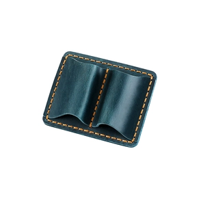 Detail of dark blue leather double pen sleeve with orange stitching and natural texture