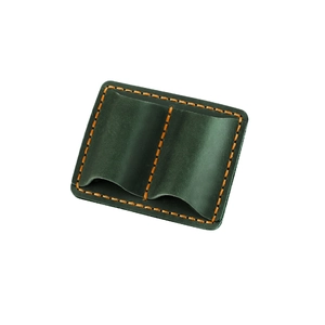 Detailed view of green leather pen holder with orange stitching and dual compartments