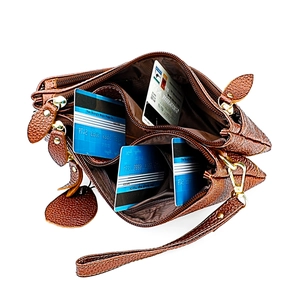 Brown litchi grain leather shoulder bag with multi-layer zipper pockets and card slots