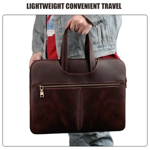 Detail of dark brown crazy horse leather laptop bag showing stitching and metal zippers