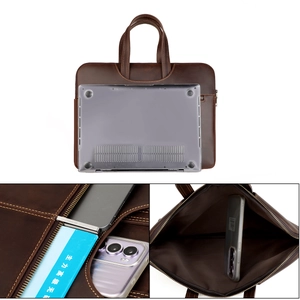 Detail view of leather laptop sleeve with precise stitching and internal storage compartments
