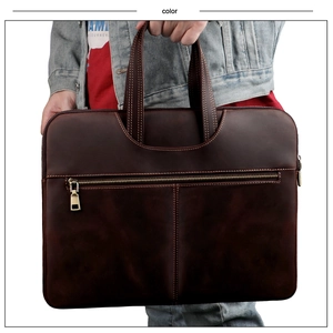 Detail of crazy horse leather laptop bag with double handles and front zipper pocket