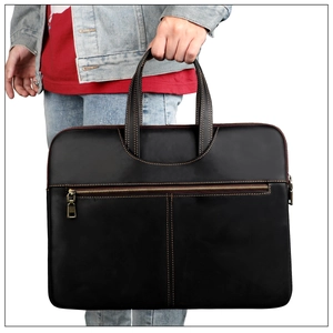 Detail of genuine black leather briefcase for MacBook Pro with yellow stitching