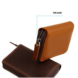 Detail view of genuine leather wallet showing pull-card feature and premium stitching