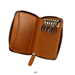 Detail of brown leather key case interior with six antique bronze hooks and card slot