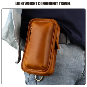 Detail of crazy horse leather phone pouch attached to belt with metal D-ring hook