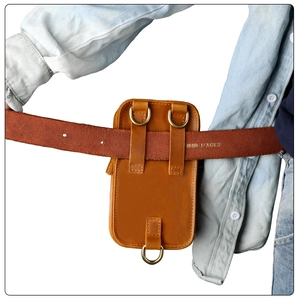 Detail of crazy horse leather belt pouch with genuine leather stamp and brass D-rings
