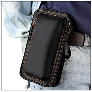 Detail of crazy horse leather phone holster worn on belt with orange stitching