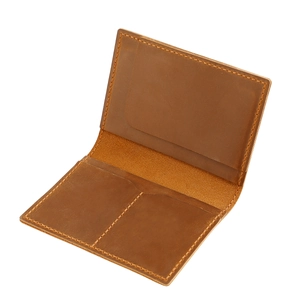 Detailed interior of a brown leather passport holder with multiple card slots and stitching