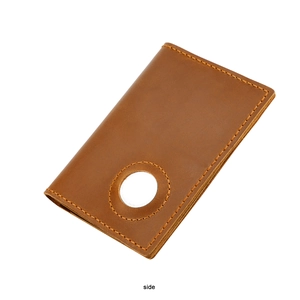 Detailed side view of brown leather passport holder with AirTag slot and orange stitching