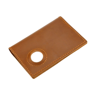 Close-up of brown leather passport holder with precise stitching and AirTag holder slot