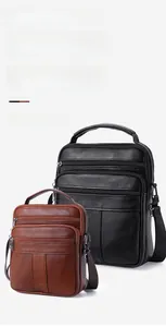 Detailed view of genuine leather cross body bags in black and brown with metal zippers