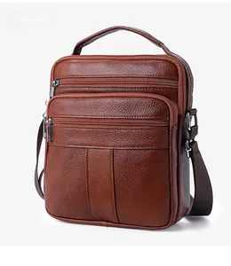 Detailed side view of brown litchi grain cowhide crossbody bag with multiple zippers