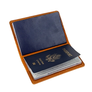 Detailed interior of brown leather passport holder with precise stitching and storage slots
