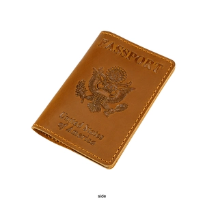 Side view of brown leather US passport cover with embossed eagle crest and yellow stitching