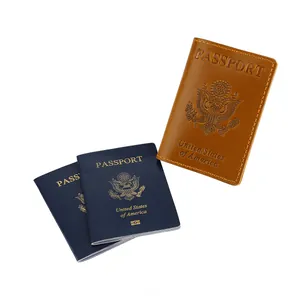 Detailed close-up of brown leather passport cover featuring embossed US national emblem design