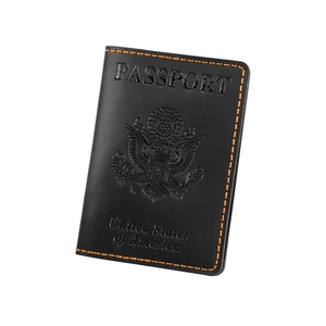 Detail of black leather US passport cover featuring orange stitching and embossed seal