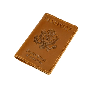 Brown leather US passport cover with vintage embossed eagle emblem and stitching