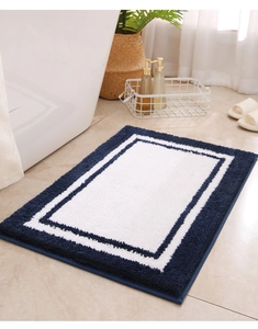 Detailed view of plush blue and white geometric bath mat with microfiber flocking texture