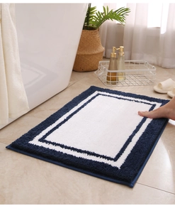 Detail of high-density flocked bath mat showing thick absorption texture on marble floor