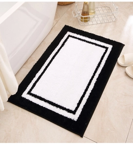 Detailed texture of a soft flocked bathroom mat with black borders in a modern setting