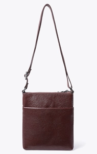 Detail view of brown leather crossbody bag with front pocket and adjustable strap