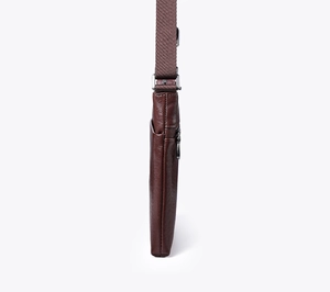 Side view of slim brown leather crossbody bag with adjustable fabric shoulder strap