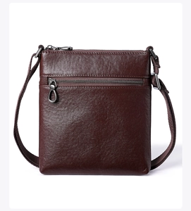 Detailed macro view of dark brown pebbled leather texture on men crossbody bag