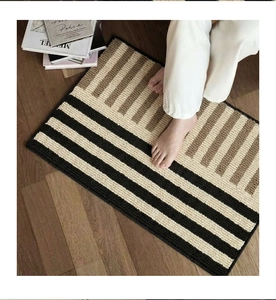 Close-up of a Nordic bathroom mat with geometric texture and non-slip surface on wood