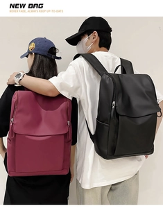 Rear view of models wearing large capacity burgundy and black waterproof travel backpacks