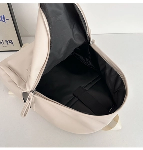Macro shot of large beige backpack interior with padded laptop sleeve and elastic strap
