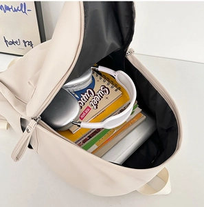 Macro view of beige backpack interior showing spacious storage for laptop and accessories
