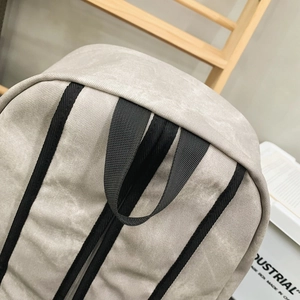 Close-up of durable gray backpack fabric texture with high-density black webbing strap