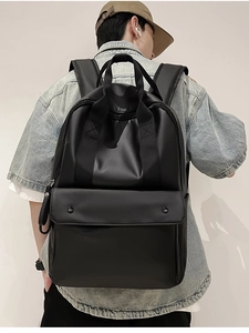Ergonomic black matte travel backpack with padded straps and large front pocket flap