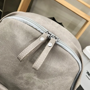 Macro detail of high-quality fabric texture and durable dual zippers on street style backpack