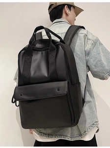 Detail of a sleek black PU leather backpack with a metal clasp on a male model outdoors