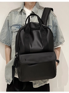Detail of waterproof matte black travel backpack with reinforced handles and metal zipper