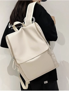 White minimalist waterproof backpack for women featuring large main compartment and front flap pocket